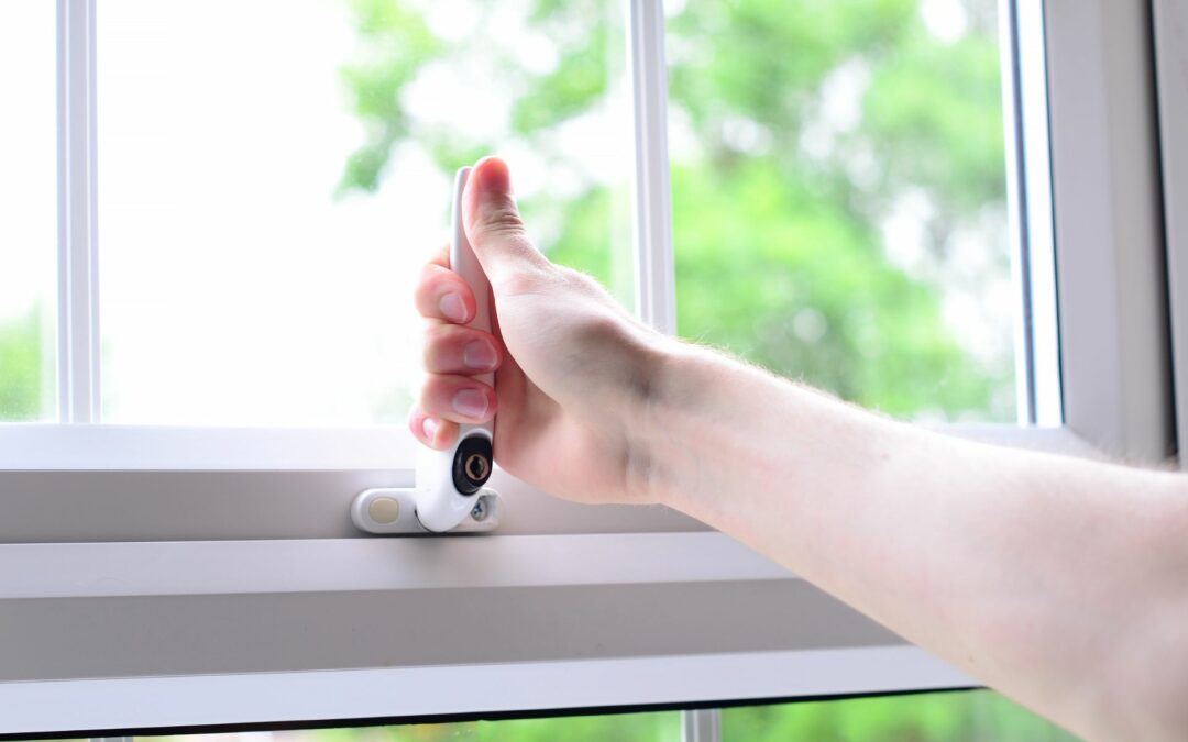 A woman installs an extra lock because she knows how to secure windows